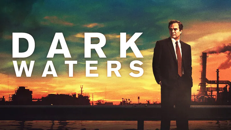 The poster for the movie Dark Waters shows a man in a suit standing in front of a factory. 