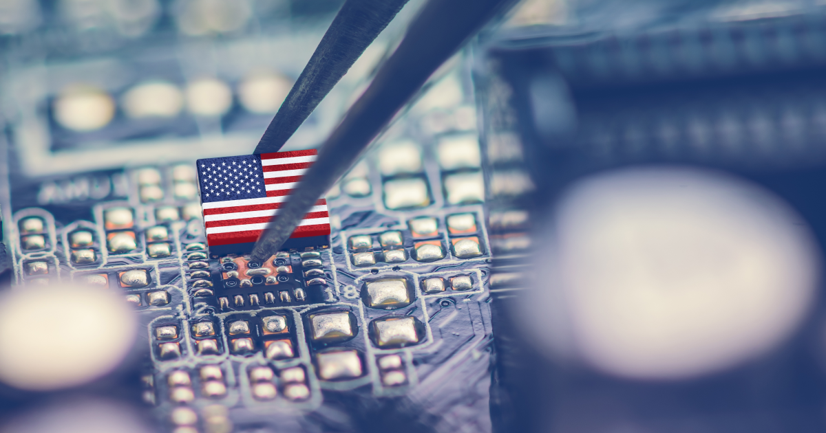 A picture of a microchip being that looks like the American flag being inserted onto a motherboard.