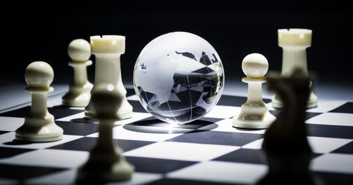 An image showing a chessboard with a globe in the middle representing geopolitics, one of the 5 supply chain megatrends of 2024. 