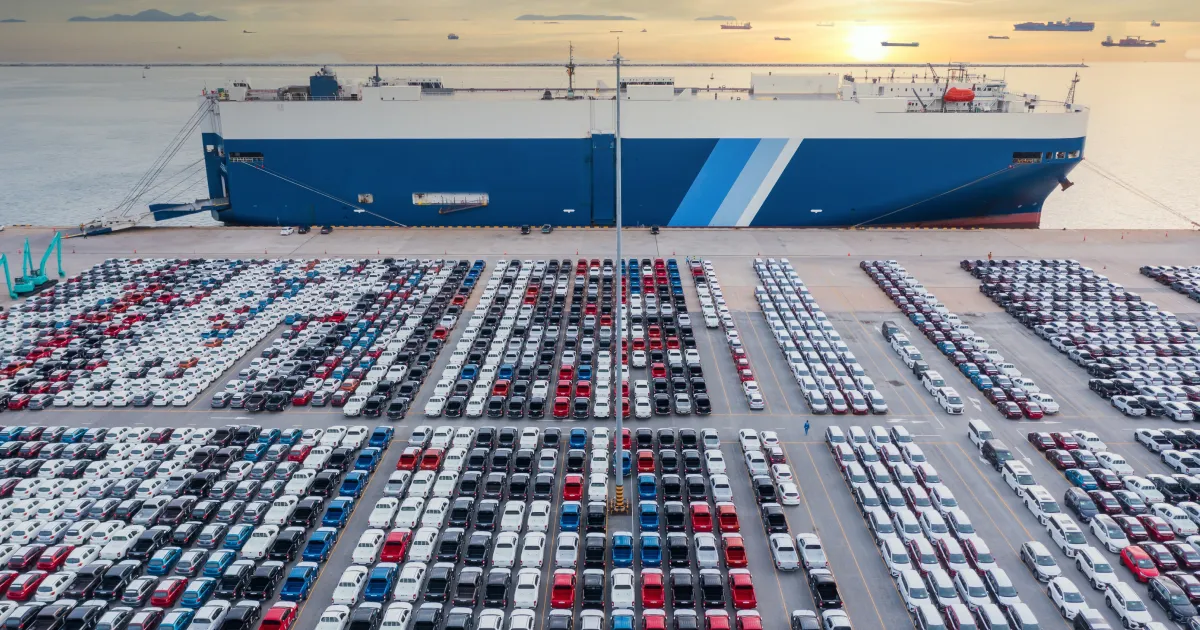A photo of cars at a port.