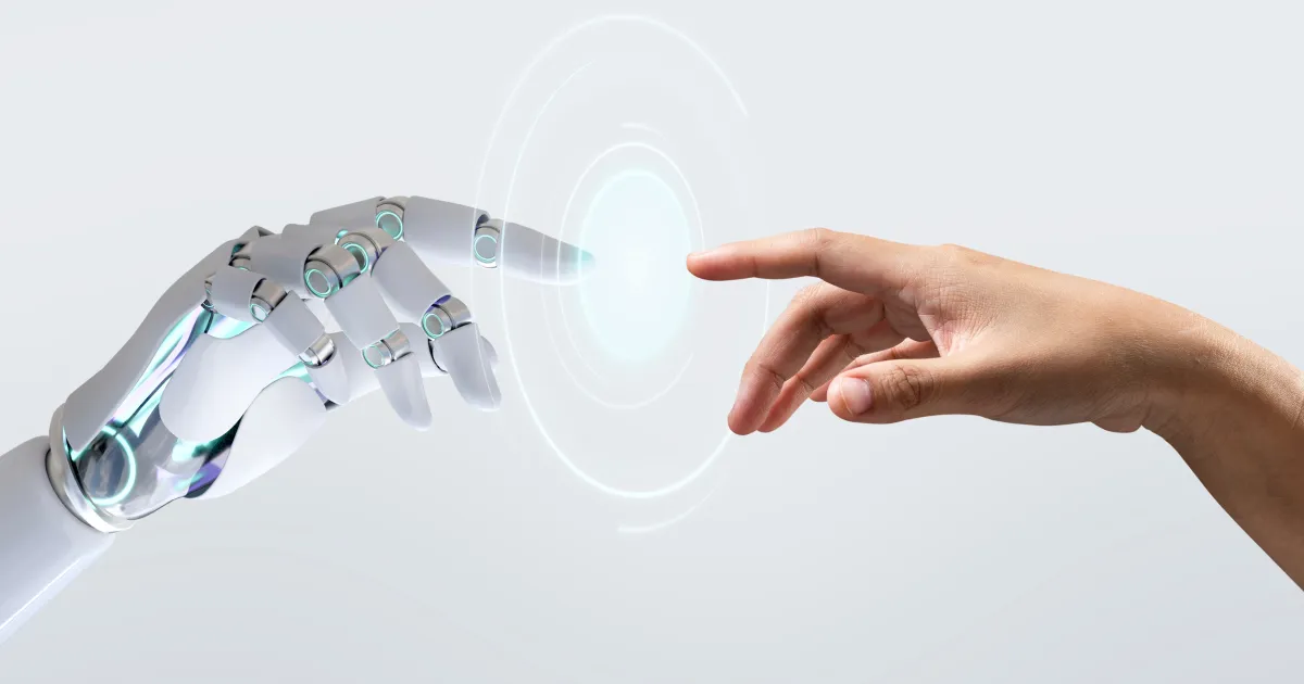 An image of a robot hand and a human hand touching. 